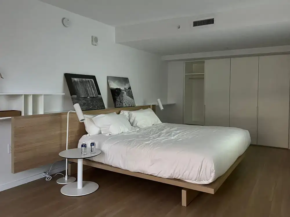 A beautifully styled minimalist bed frame in a calm room