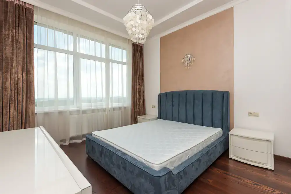 Elegant wooden and upholstered bed frames in a bright showroom