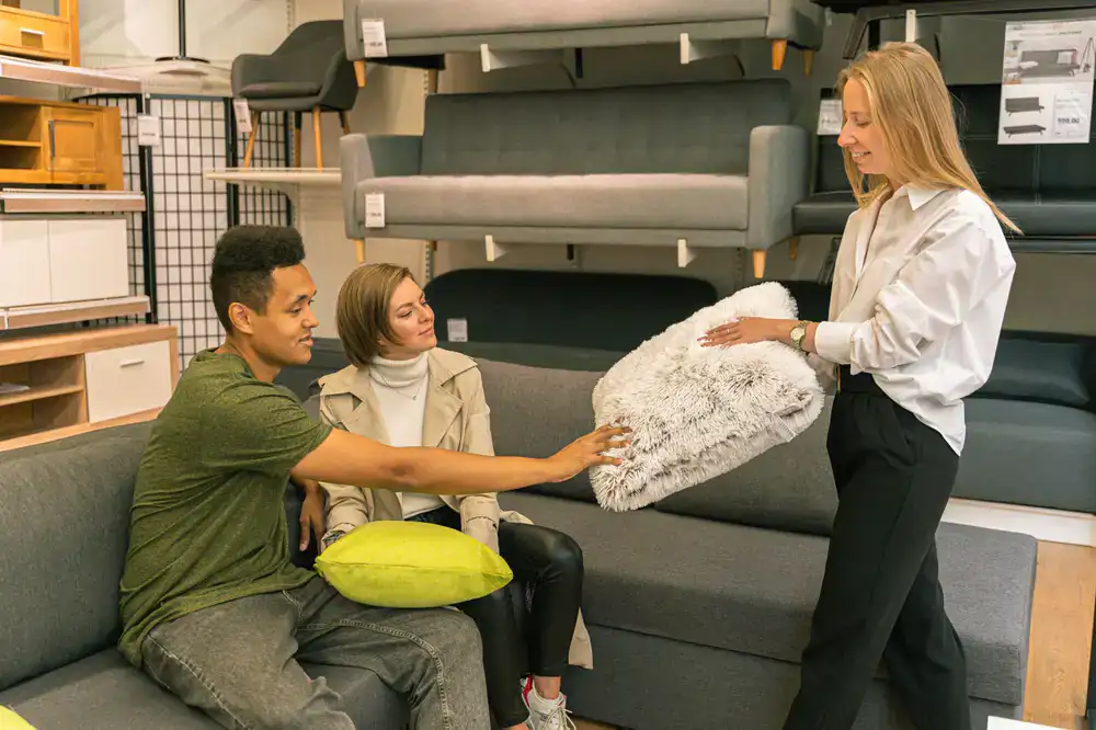 Consultant helping a customer choose the right mattress firmness