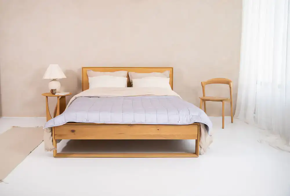 A cleanly made bed showing a quality mattress protector